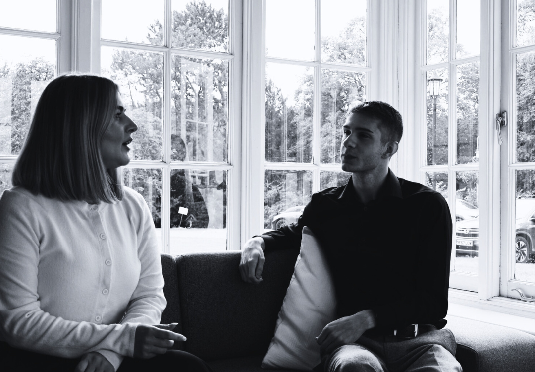 male and female workers wearing suits and hard hats