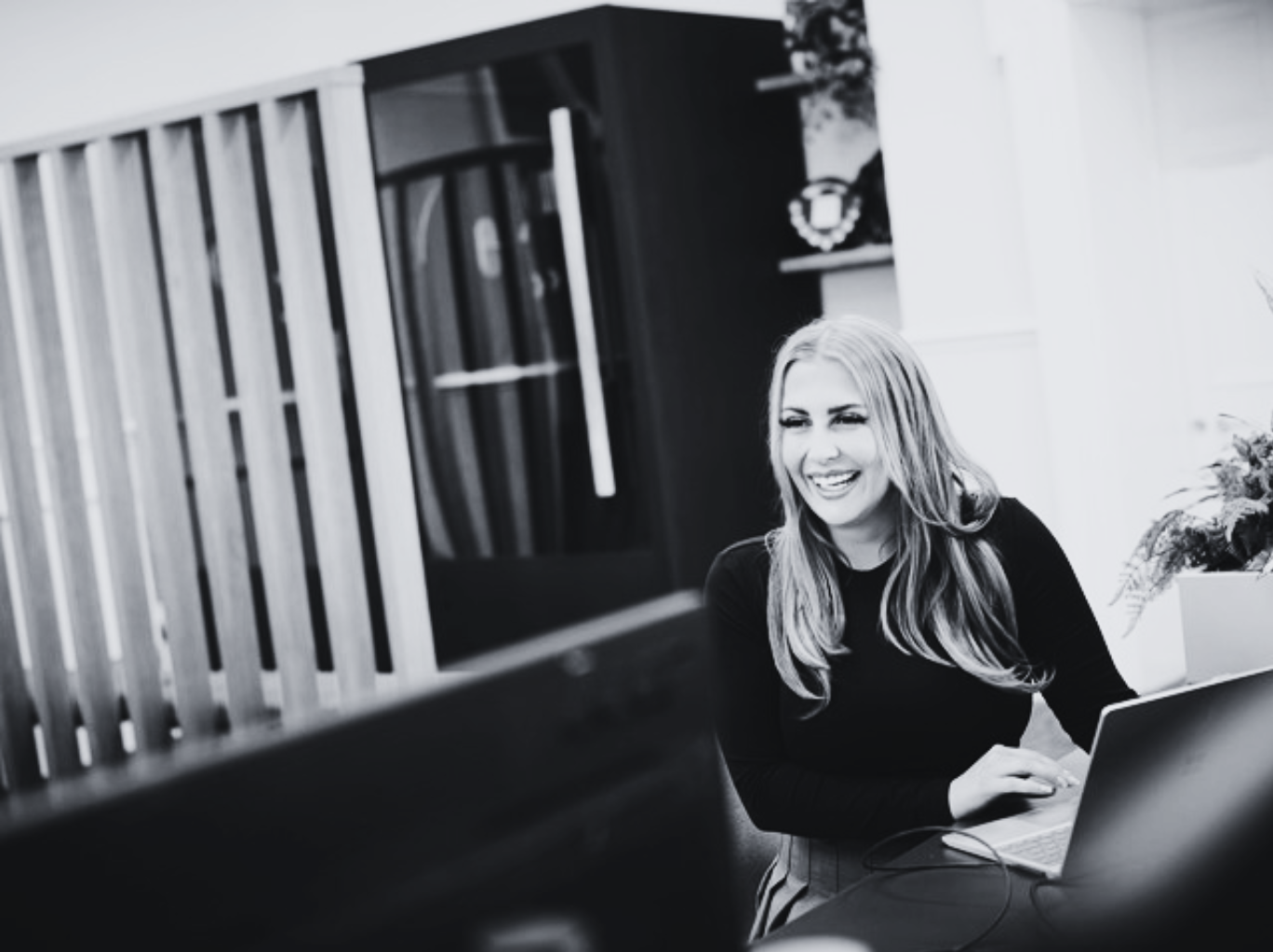 woman in an office smiling