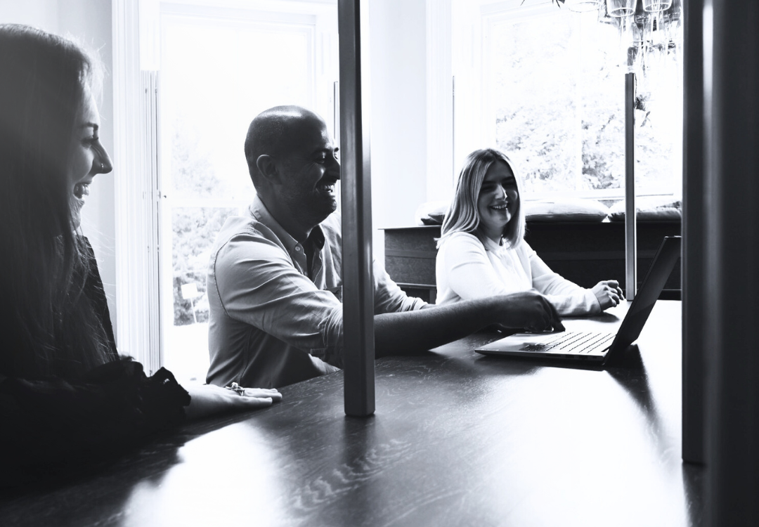 people sat around a table talking